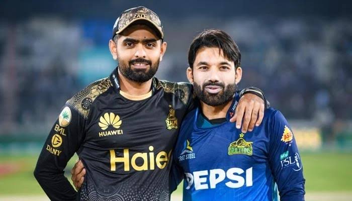 Two cricketers in team jerseys smiling at the camera