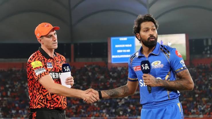 Two cricket players shaking hands during IPL match