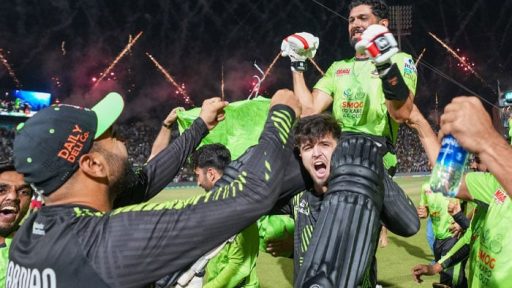 Cricket team celebrates victory with fireworks in background