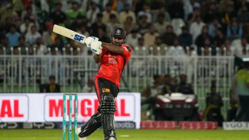 Cricketer playing a shot during night match
